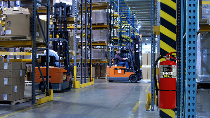 warehouse with forklift shelves and fire extinguisher