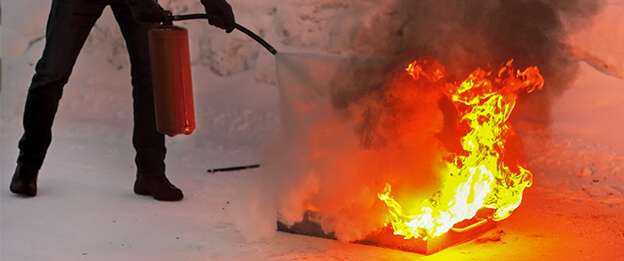 Person using a fire extinguishers during a Fire Simulator Training